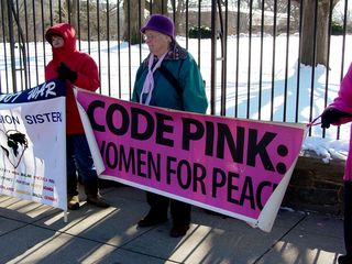 On the sidewalk immediately next to the White House fence, a group of women organized under the name Code Pink was protesting the then-upcoming war with Iraq.